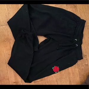 Kids Black Sweat Pants with Flower ‘logo’.